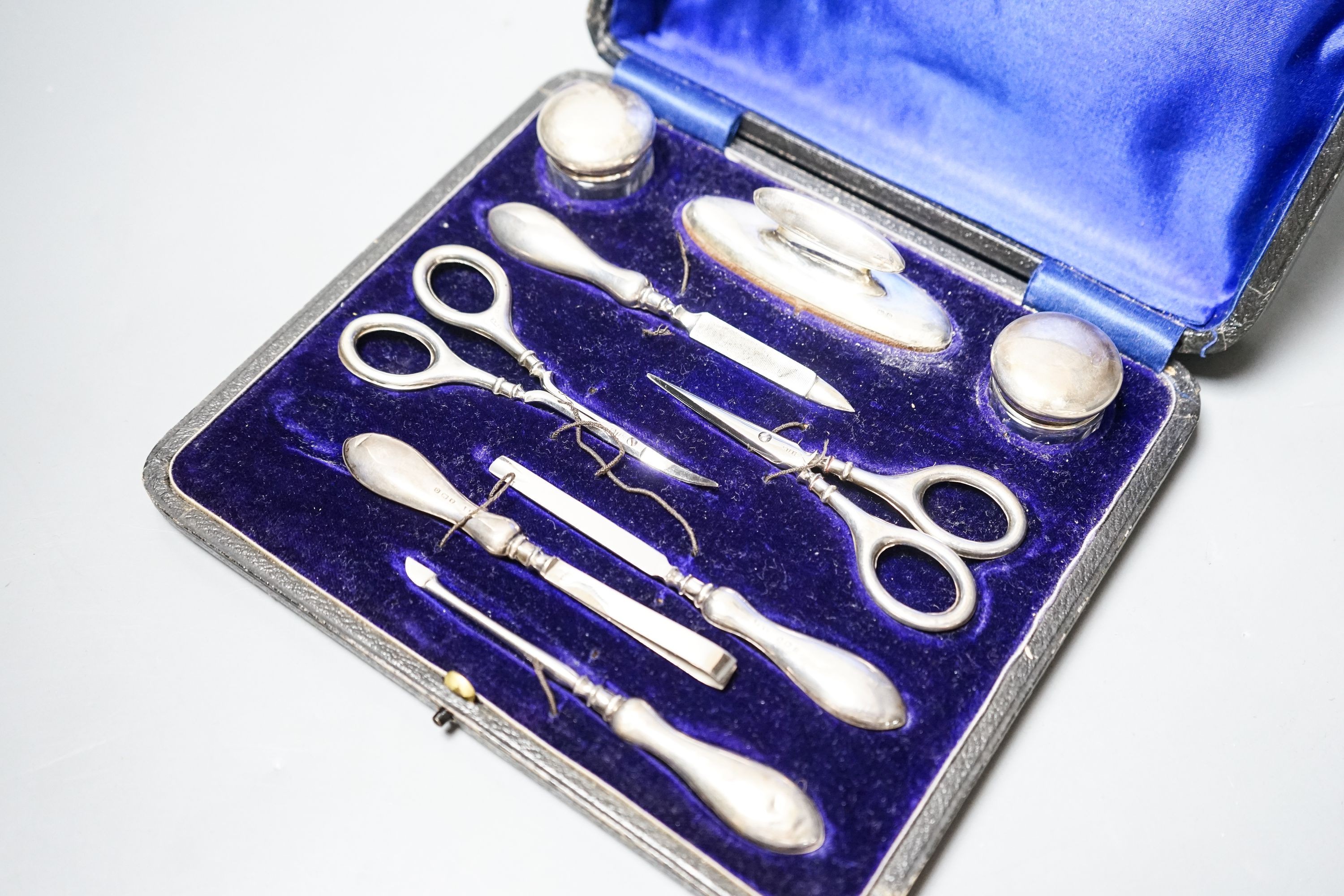 A cased silver mounted nine piece manicure set.